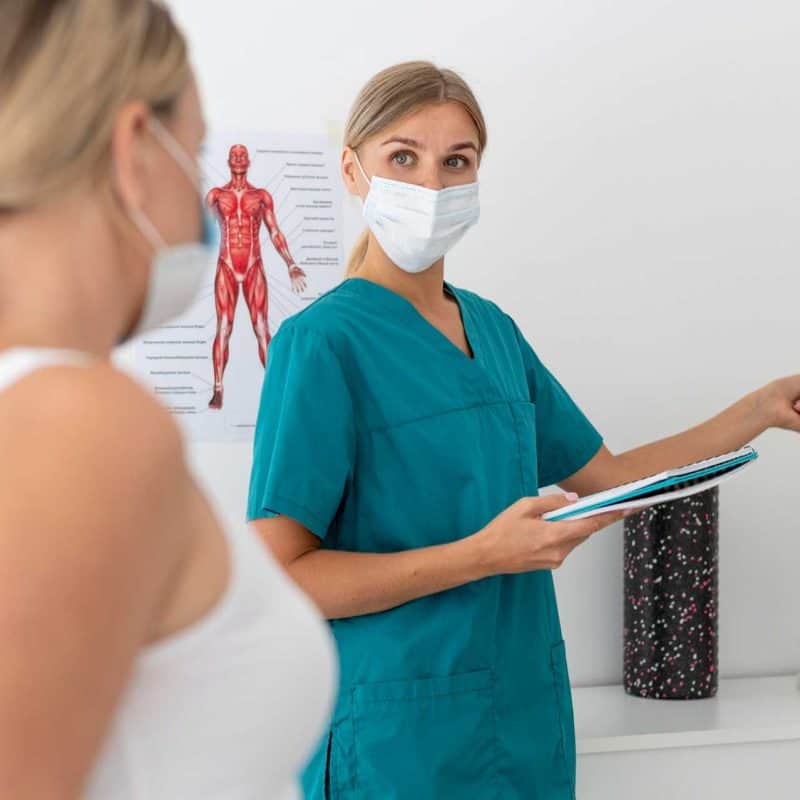 Chiropractor discussing treatment options with patient during initial consultation
