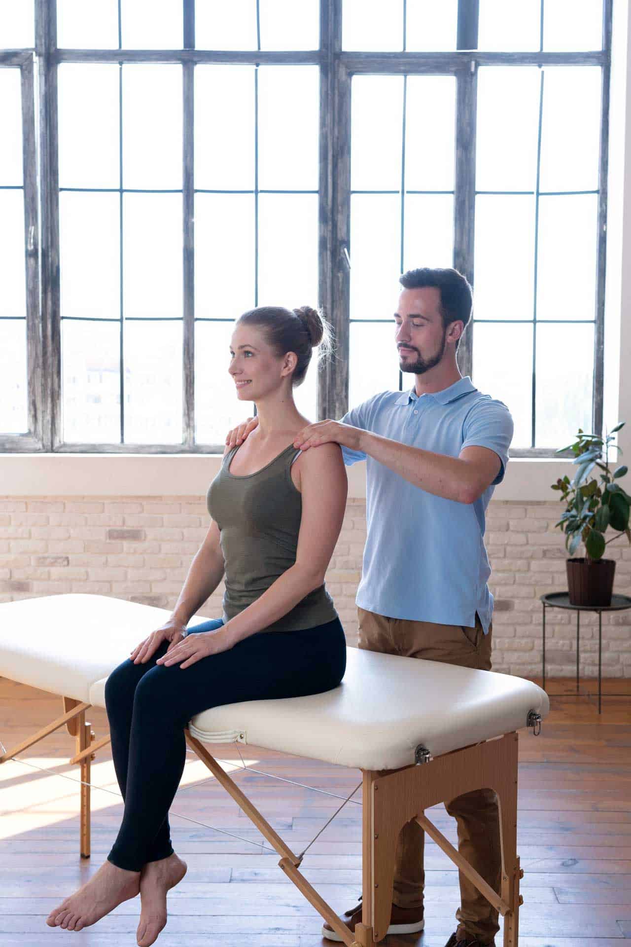 Chiropractic adjustment being performed on a woman in a modern clinic.