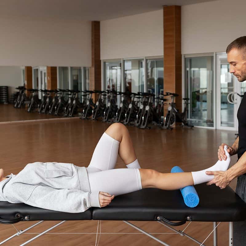 Physical therapist assisting patient with rehabilitation exercises at Eatontown Elite Care Center in Monmouth County, NJ